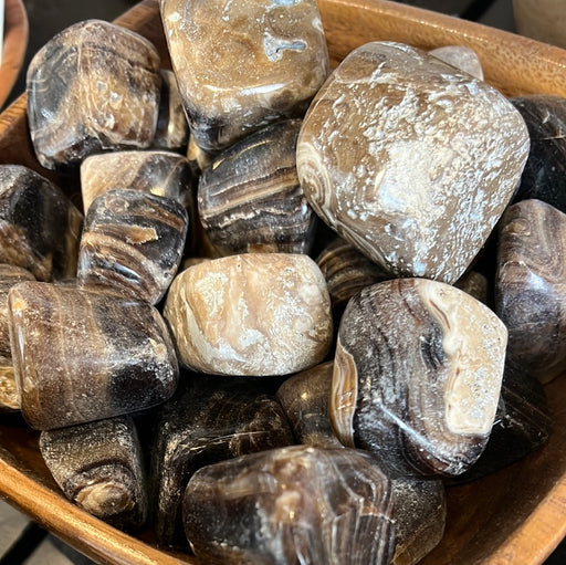 Beautifully polished Chocolate Calcite tumbled stone from Pakistan, perfect for crystal healing and decoration.