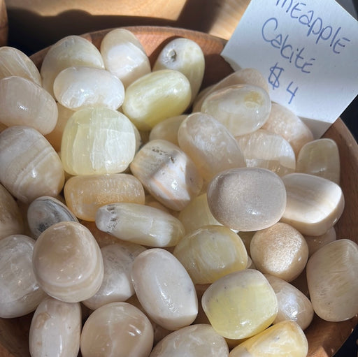 Pineapple Calcite Tumbled stone from High Ho Gems and Crystals, showcasing its unique yellow and orange hues.