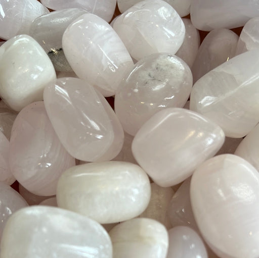 Beautiful Rose Pink Calcite Tumbled stones sourced from Pakistan, showcasing their soft pink hues and unique crystal formations.