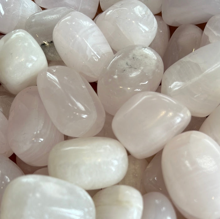 Beautiful Rose Pink Calcite Tumbled stones sourced from Pakistan, showcasing their soft pink hues and unique crystal formations.