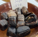 Close-up view of Chocolate Jasper tumbled stones, showcasing their unique purple color and natural texture, ideal for crystal collectors and healing enthusiasts.