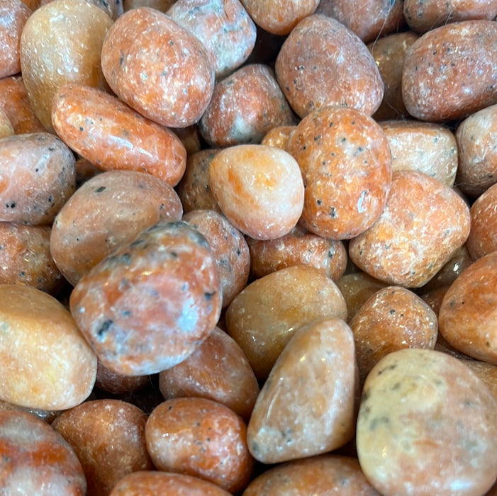 Orchid Calcite Tumbled stones showcasing their unique colors and texture, perfect for crystal healing and decoration.