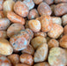 Orchid Calcite Tumbled stones showcasing their unique colors and texture, perfect for crystal healing and decoration.