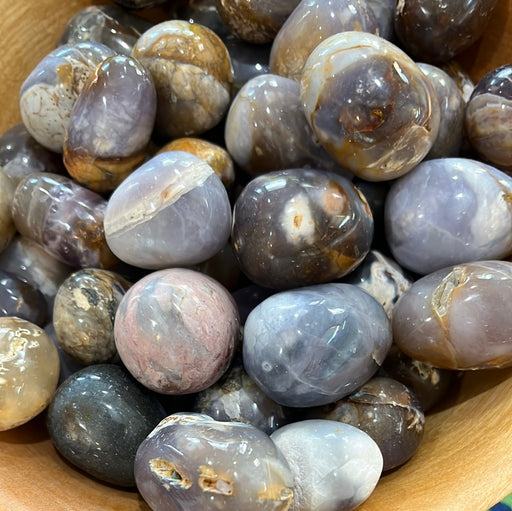 Beautiful Purple Chalcedony Tumbled stones showcasing varying shades of purple, perfect for crystal healing and decorative use.