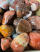 Beautiful Red South Agate Tumbled stones showcasing vibrant red colors, perfect for healing and decorative purposes.