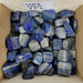 Close-up of Lapis Lazuli Tumbled stones highlighting the rich blue hues and natural patterns, ideal for home decor or meditation.
