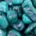A collection of Malachite tumbled stones in various shapes and sizes, emphasizing their beautiful green hues. Perfect for energy work and manifesting abundance.