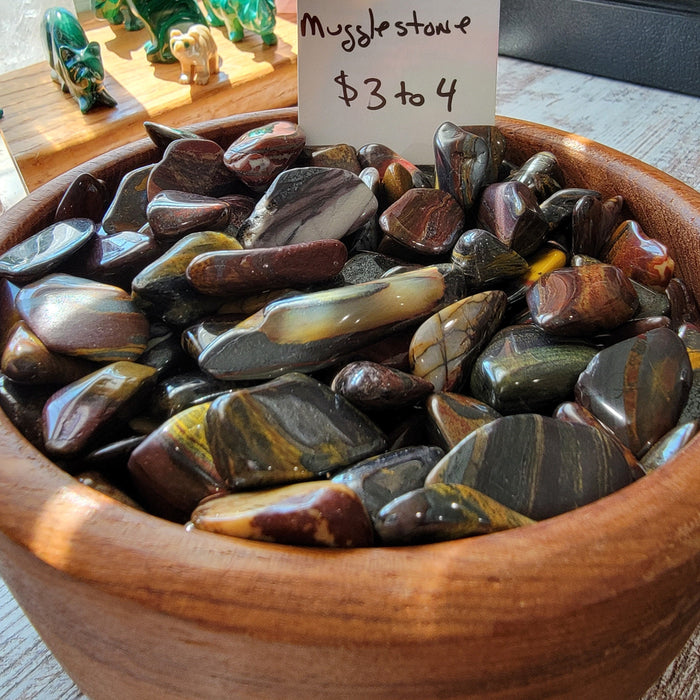 Mugglestone tumbled stone showcasing its unique patterns and colors, perfect for grounding and creativity.