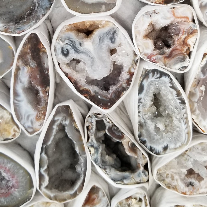 Stunning Oco Geode showcasing vibrant colors in black, brown, grey, and white, perfect for enhancing energy and meditation.