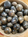 Beautiful Stromatolite tumbled stones showcasing vibrant colors like green, yellow, and brown, perfect for healing and meditation.