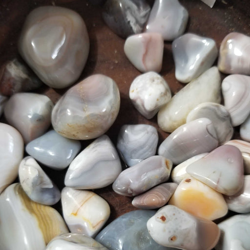 Pink Botswana Agate Tumbled Stone for Root Chakra - Close-up of a Pink Botswana Agate tumbled stone highlighting its intricate patterns and calming energy.