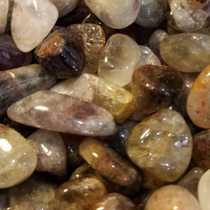 Super 7 Melody Stone chips showcasing a variety of vibrant colors ranging from peach and pink to green and gray, perfect for crystal healing and enhancing psychic abilities.