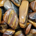 High-quality Yellow Jasper Tumbled stone showcasing its vibrant yellow color ideal for crystal enthusiasts and collectors.